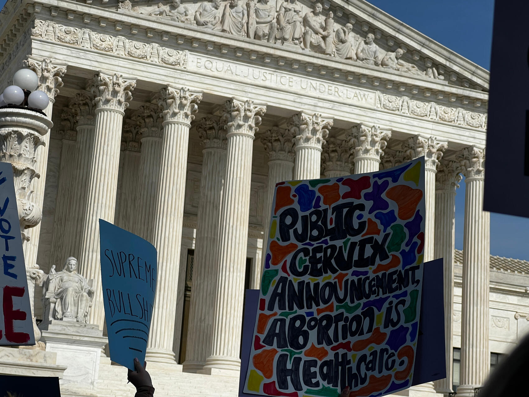 Protest signs outside SCOTUS 4/3/22